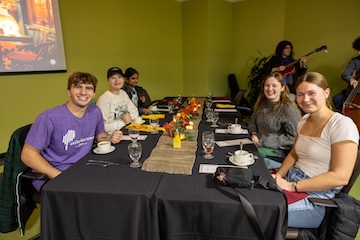MSU students gather around a table at a recent experiential dining event.
